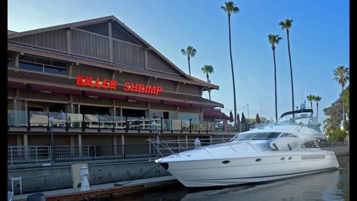 Killer Shrimp Marina del Rey waterfront exterior with the iconic sign and yacht